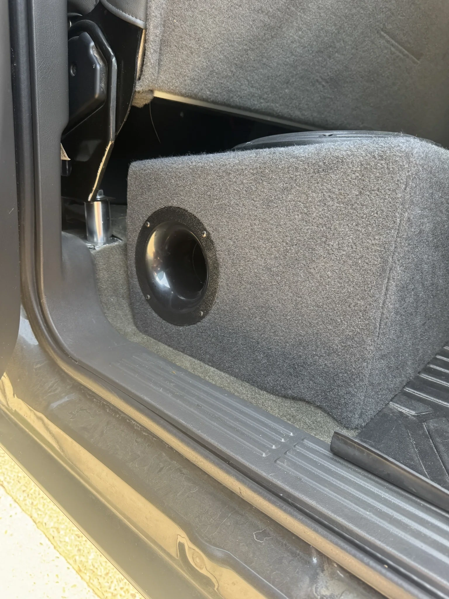 Port flare on the end of a custom fiberglass under-seat subwoofer enclosure