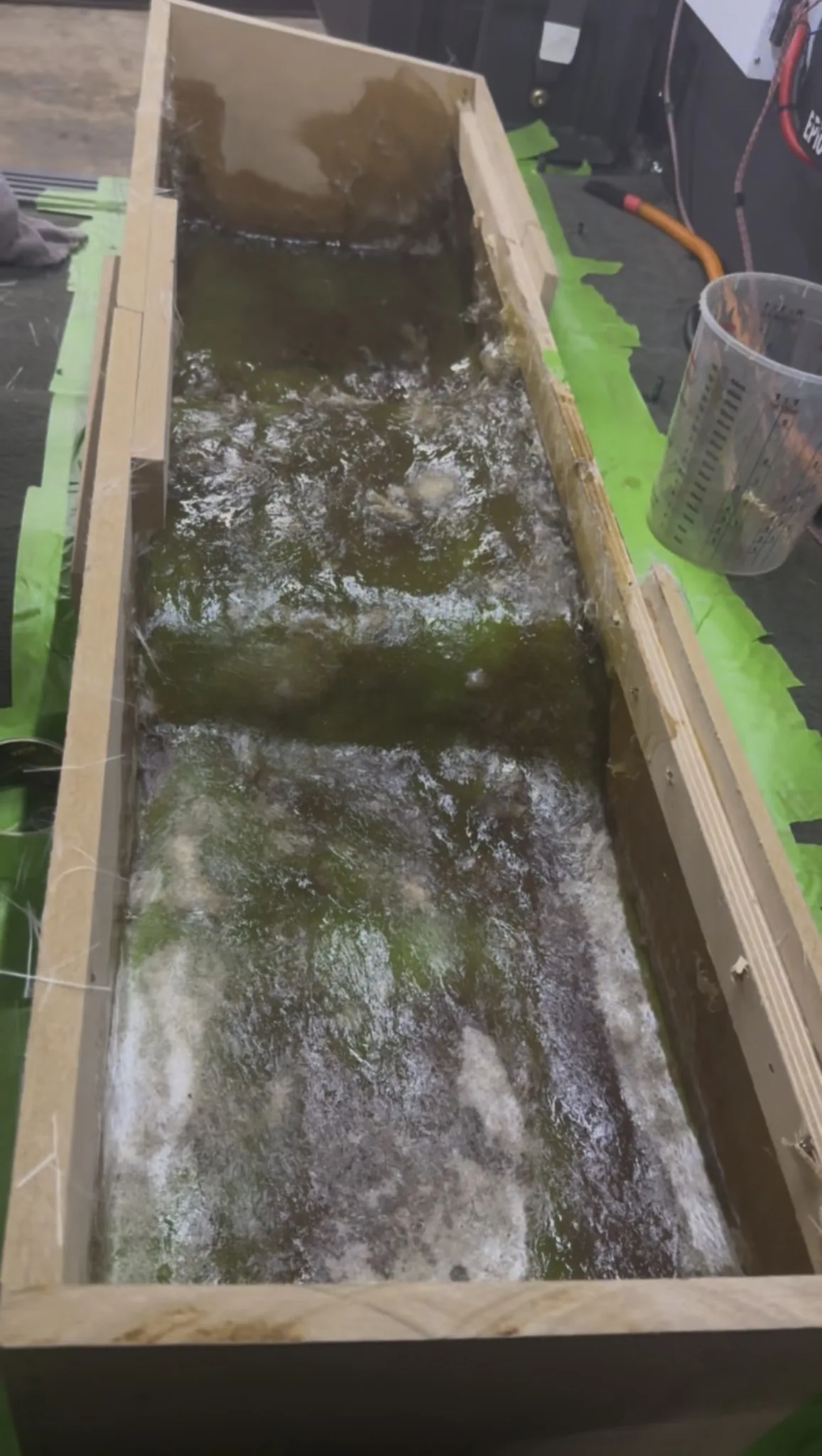 Fiberglass resin curing inside the enclosure form for a custom under-seat subwoofer box